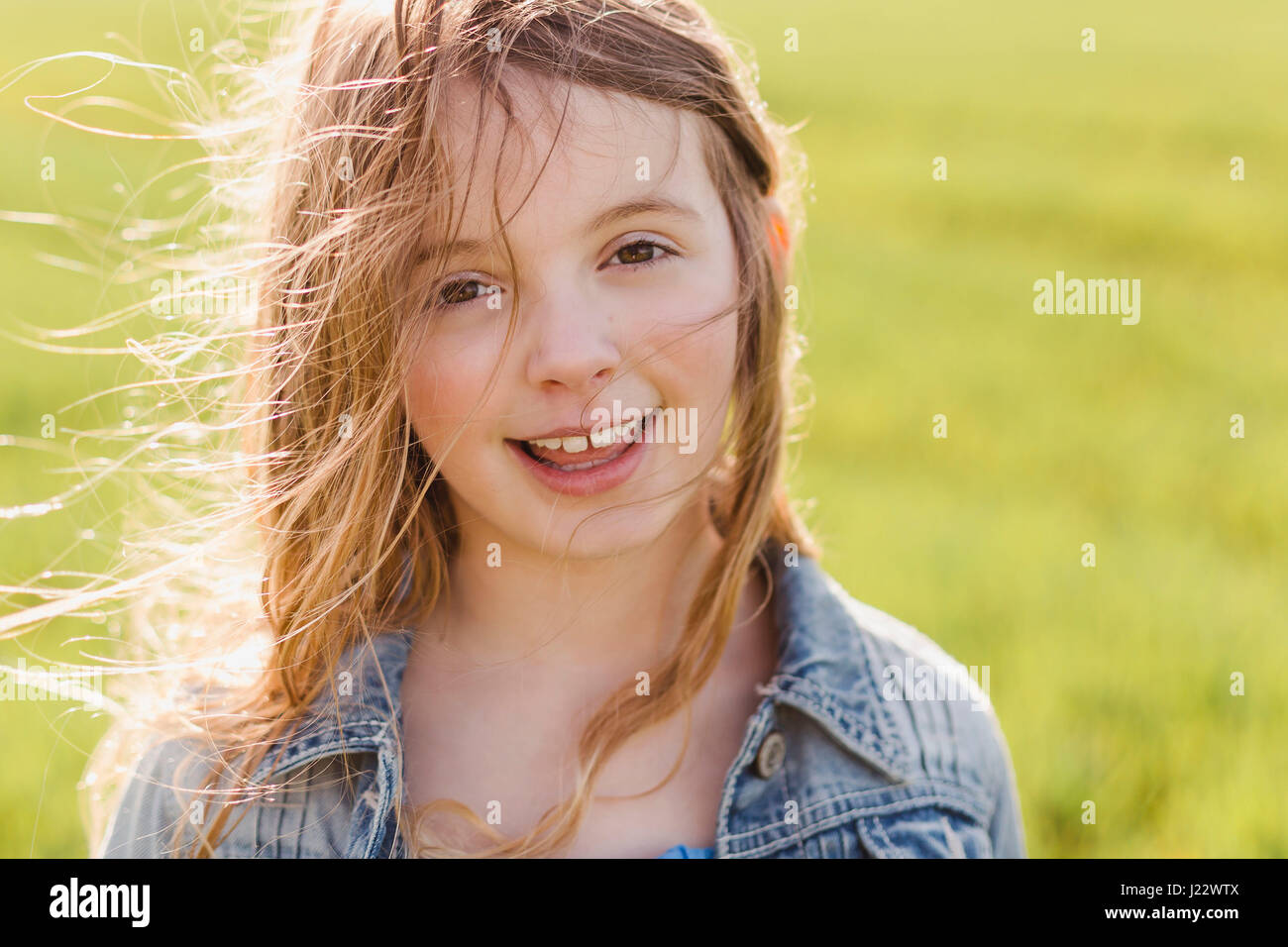 Portrait of smiling girl with blowing hair Stock Photo