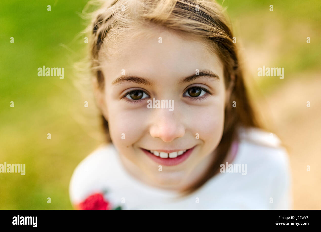 Portrait of a smiling girl outdoors Stock Photo - Alamy