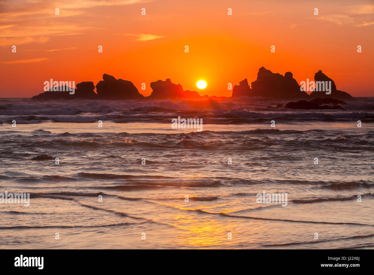 Sunset over Cat and Kitten Rocks, sea stacks at Bandon Beach along the Oregon coast, Oregon, USA. Stock Photo