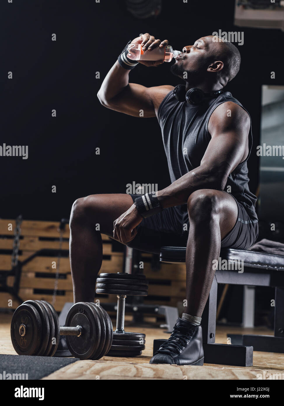 Athlete in gym relaxing after training Stock Photo