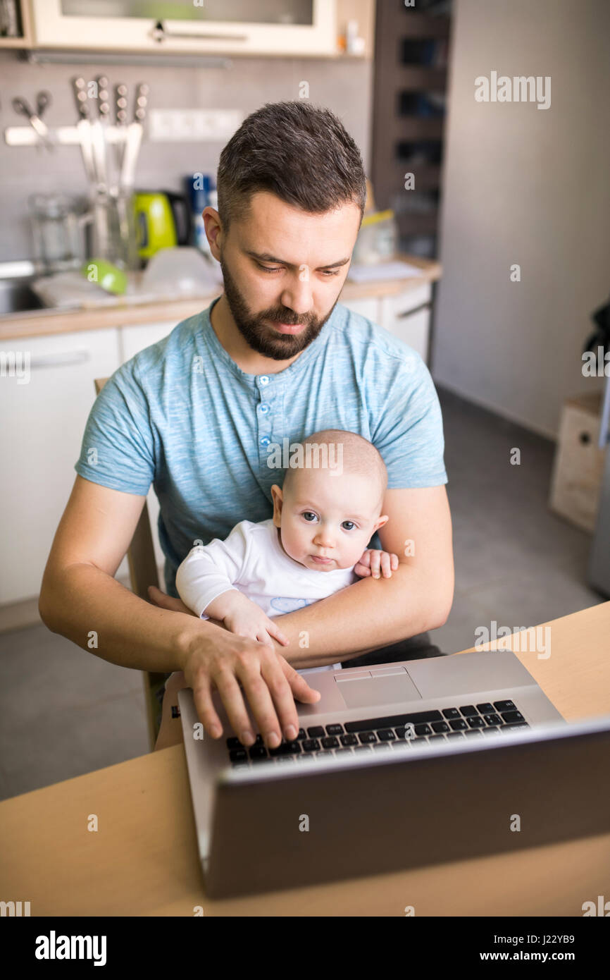 Father with baby son using laptop at home Stock Photo - Alamy