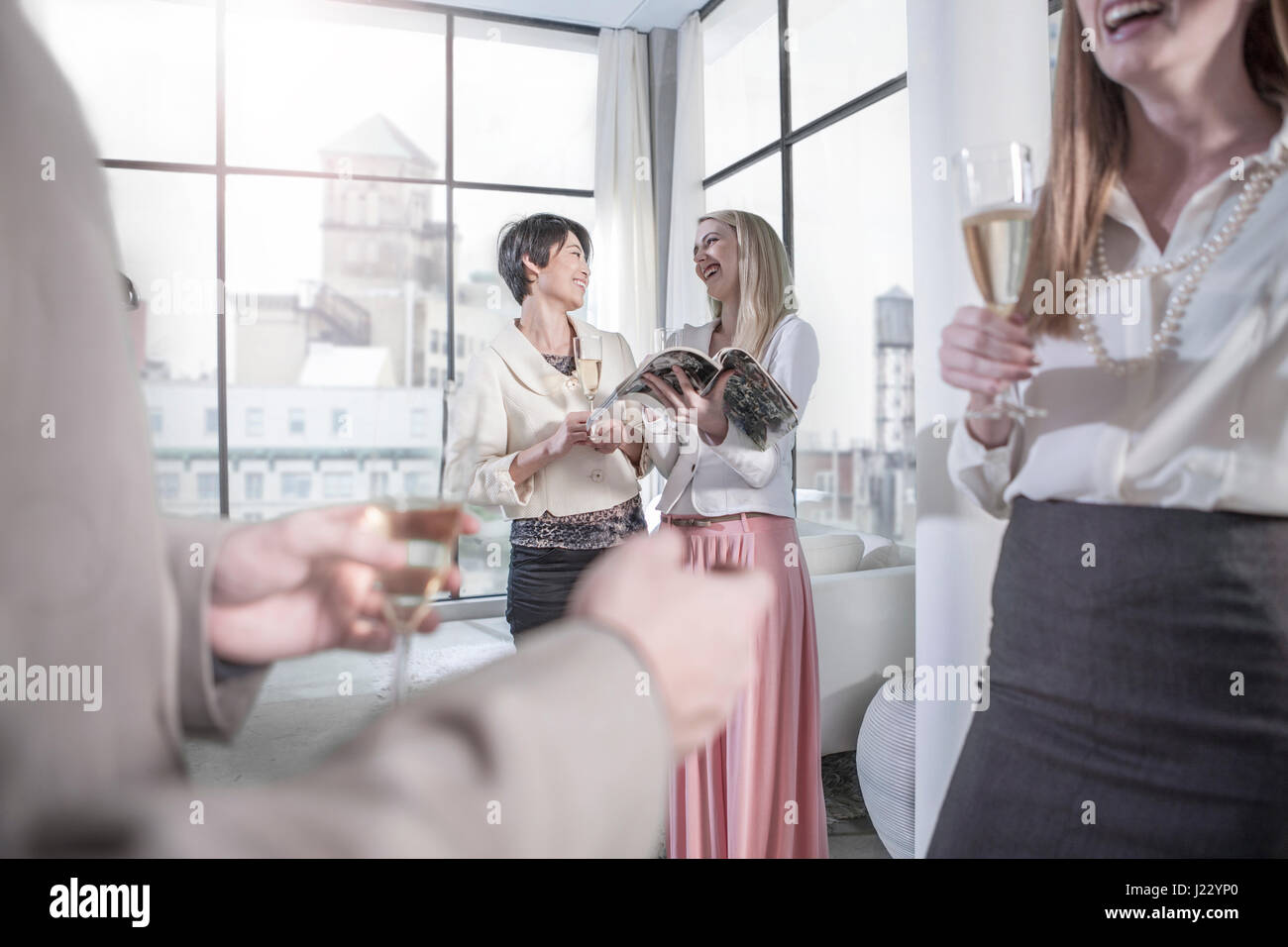 Friends socializing in a city apartment Stock Photo