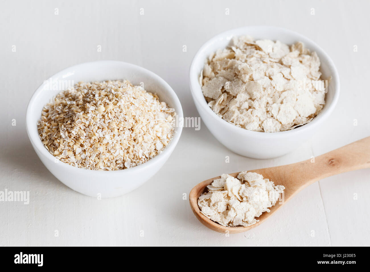 Bowls of oat bran and oat bran flakes Stock Photo Alamy