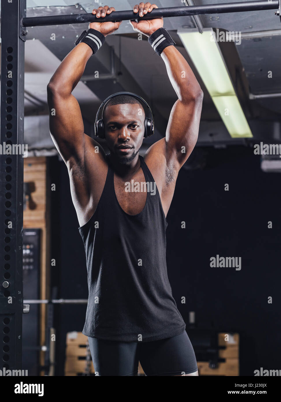 Athlete standing in gym, preparing for training Stock Photo