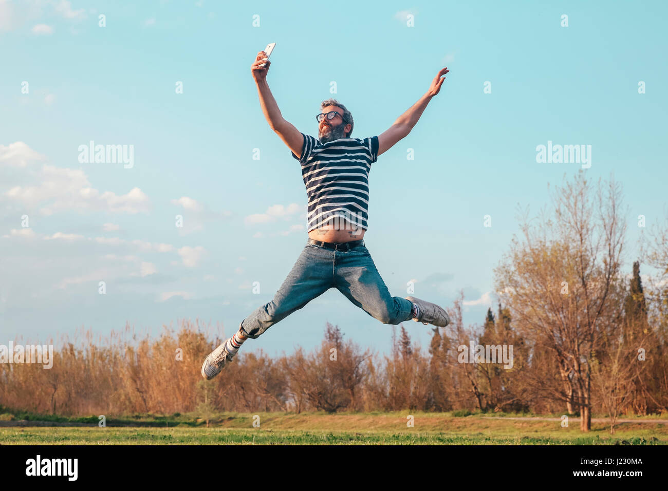 Jump jumping for joy joyful hi-res stock photography and images