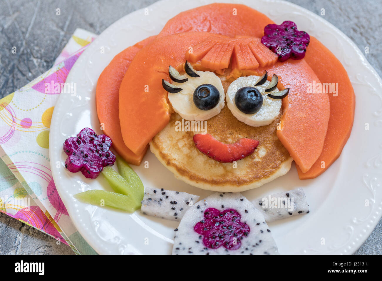 Funny girl pancake face with fruits Stock Photo Alamy