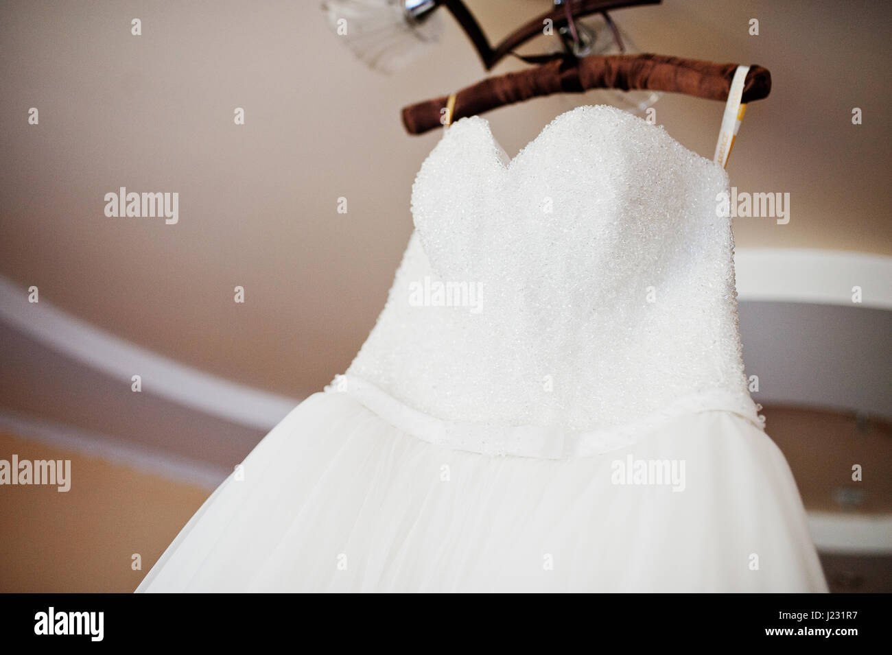 Wedding dress on hangers at ceilling. Stock Photo