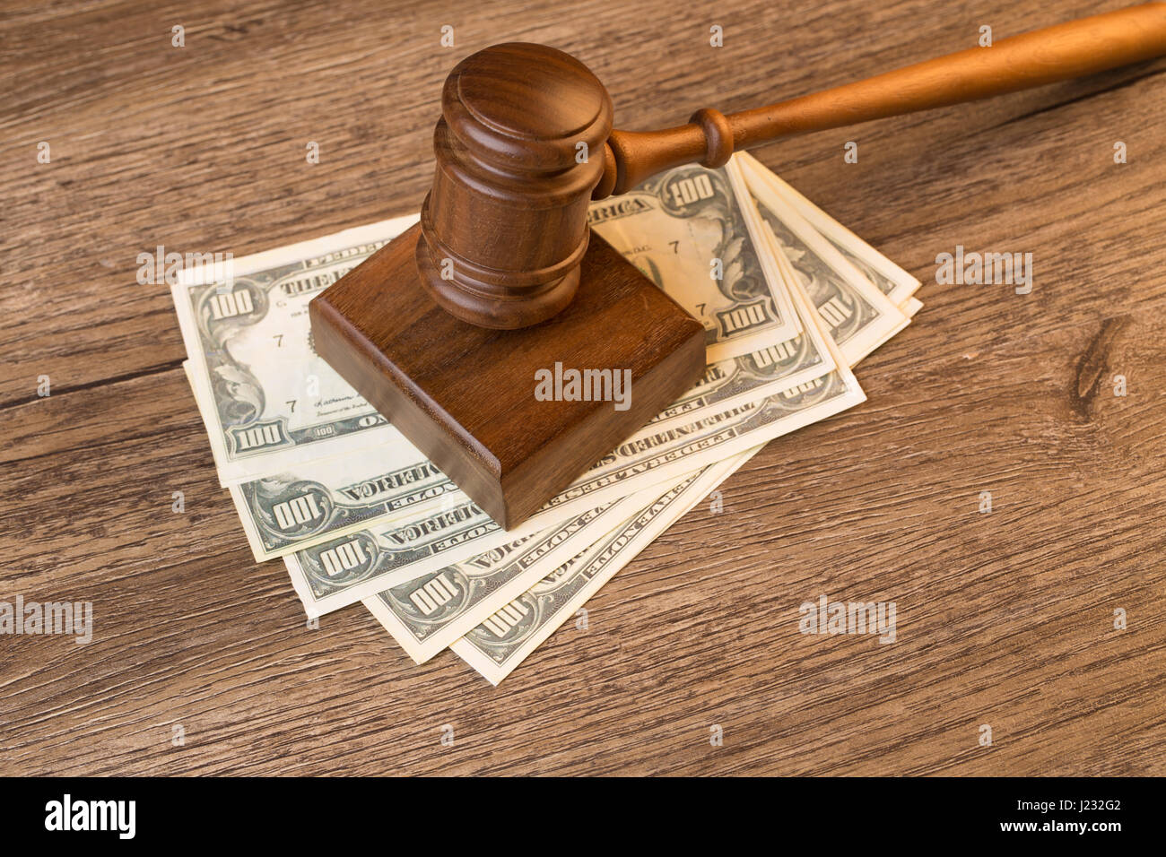 Photo of hammer on banknotes Stock Photo