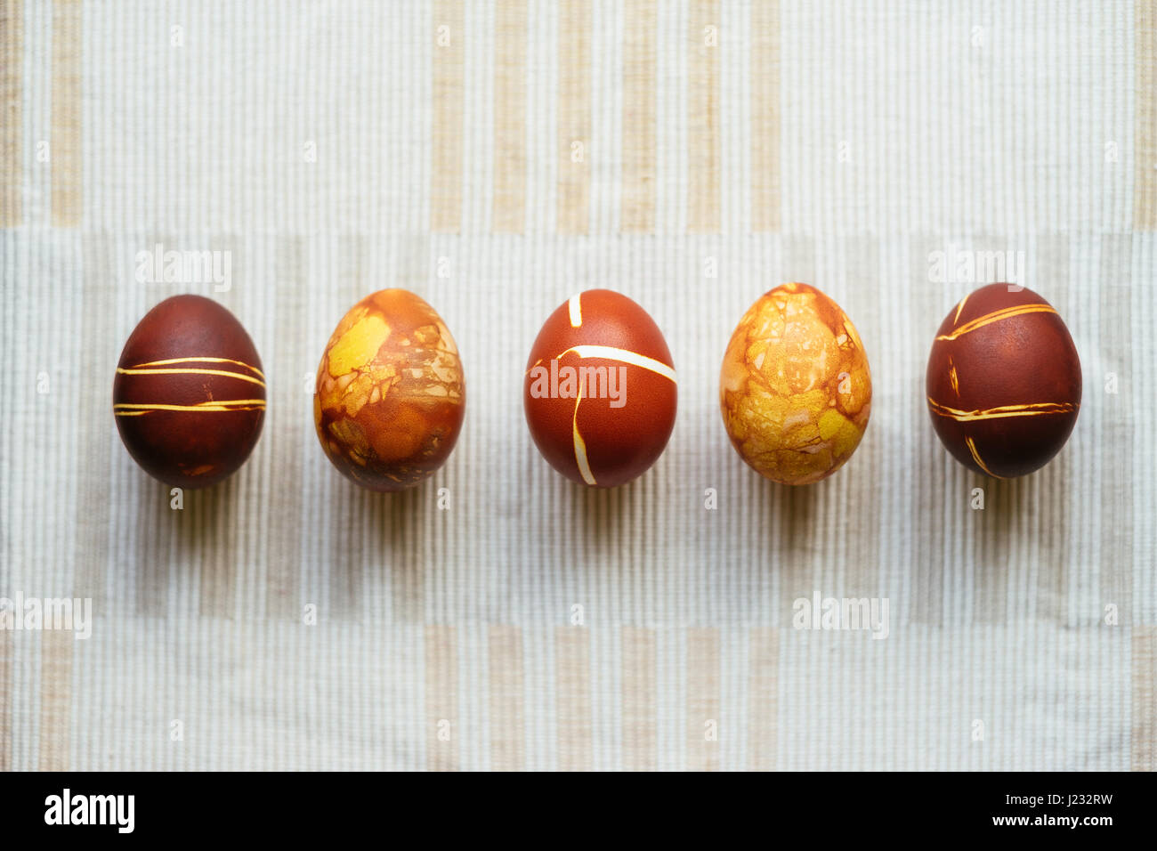 Five decorated Easter eggs, unusual home made painting with onion skins Stock Photo