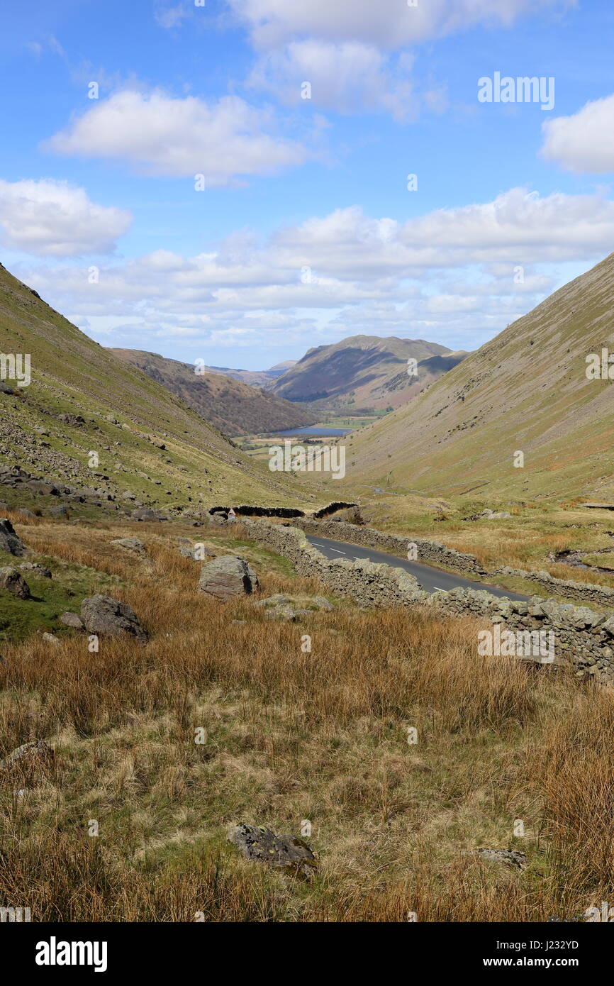 The precipitous Kirkstone Pass road winding down hill, steeply, to Brotherswater and Patterdale in the English Lake District National Park. Stock Photo