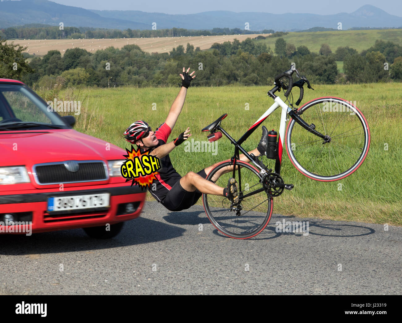 Accident cars with biker. Car collides cyclist on the road. Dangerous traffic on asphalt way on the countryside. Stock Photo