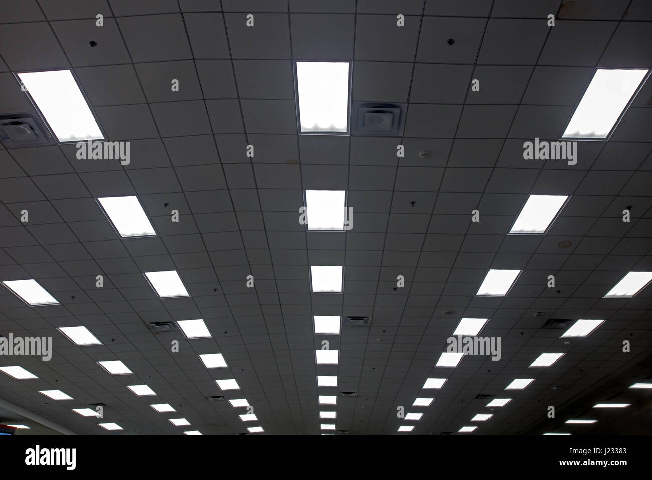 Lights in long line on ceiling of hall Stock Photo