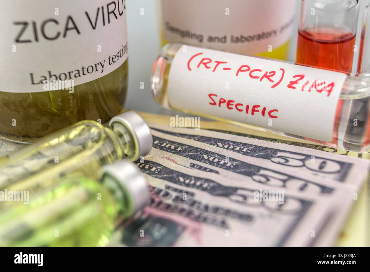 Tests for Research of ZIKA test and vials on tickets of dollar Americans, concept of pharmaceutical copayment Stock Photo