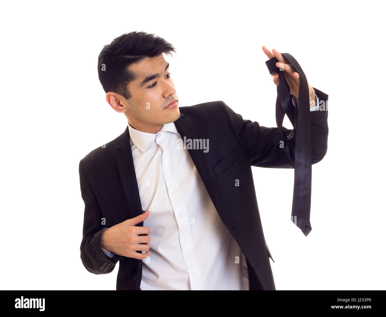 Young man in suit fixing his tie Stock Photo - Alamy