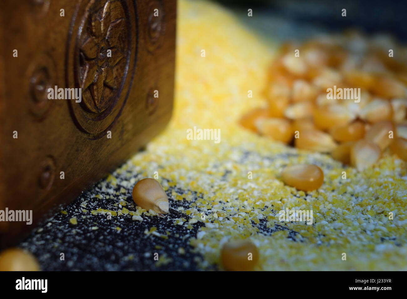 Close-up shoot of  handicraft carved chest side set on ground corn and corn beans on a wooden table. Stock Photo