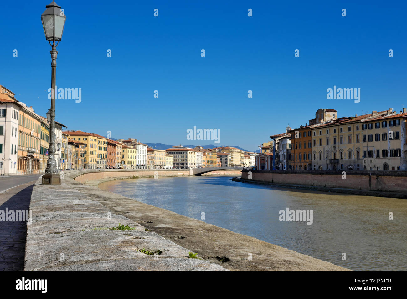 Urban landscape (cityscape) from Arno riverside - Angled view of Ponte di Mezzo Bridge, Pisa, Tuscany, Italy, Europe - City lamppost in foreground Stock Photo