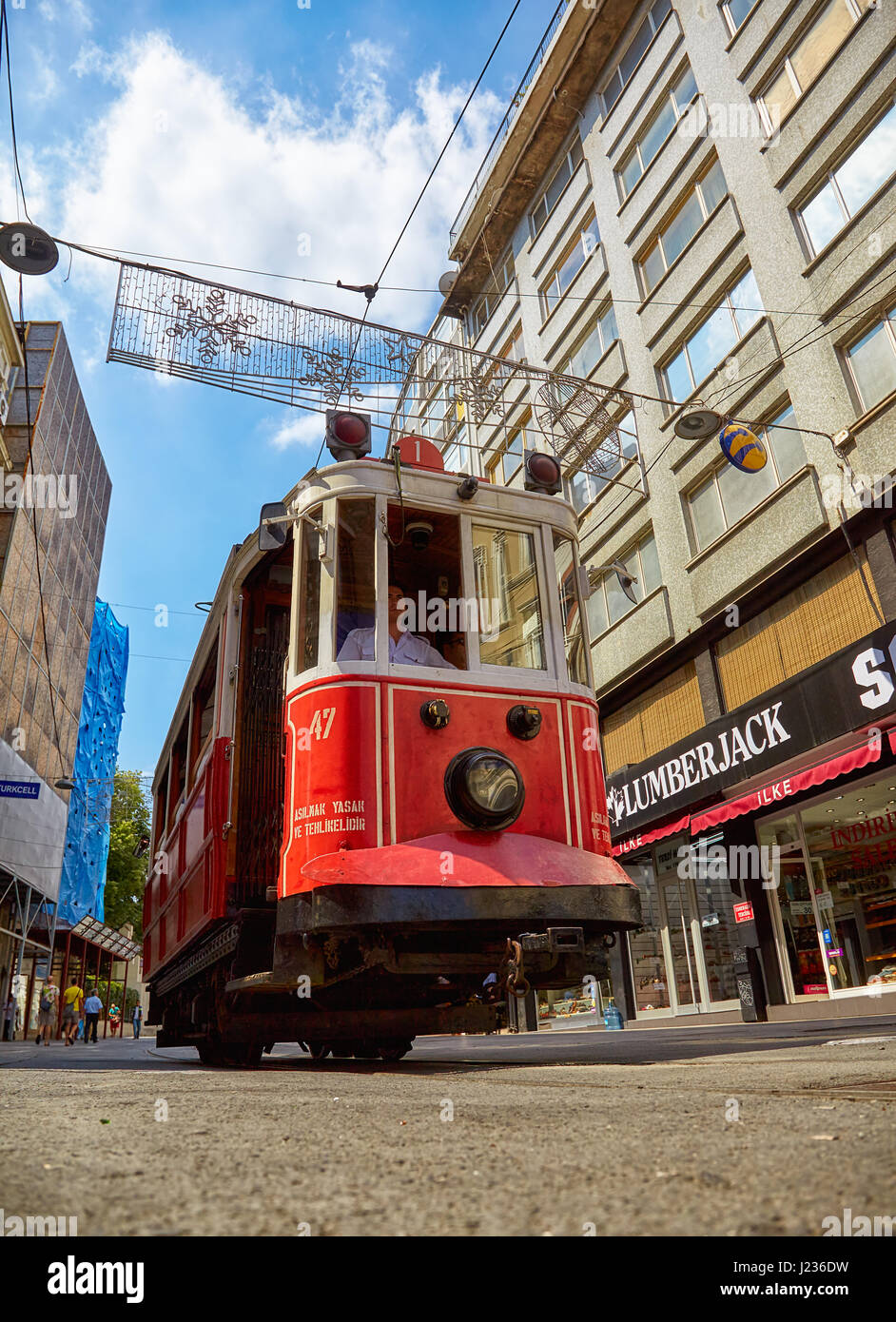 ISTANBUL, TURKEY - JULY 13, 2014:  Heritage trams of a Taksim-Tunel Nostalgia Tramway line operates on Istiklal Street between Taksim Square and under Stock Photo