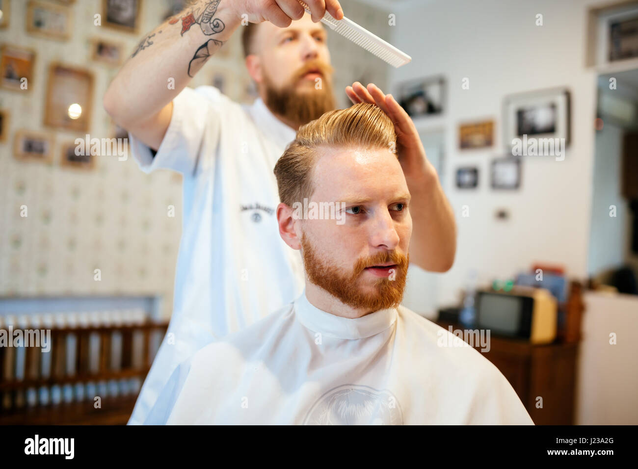 Professional barber styling hair hi-res stock photography and images ...