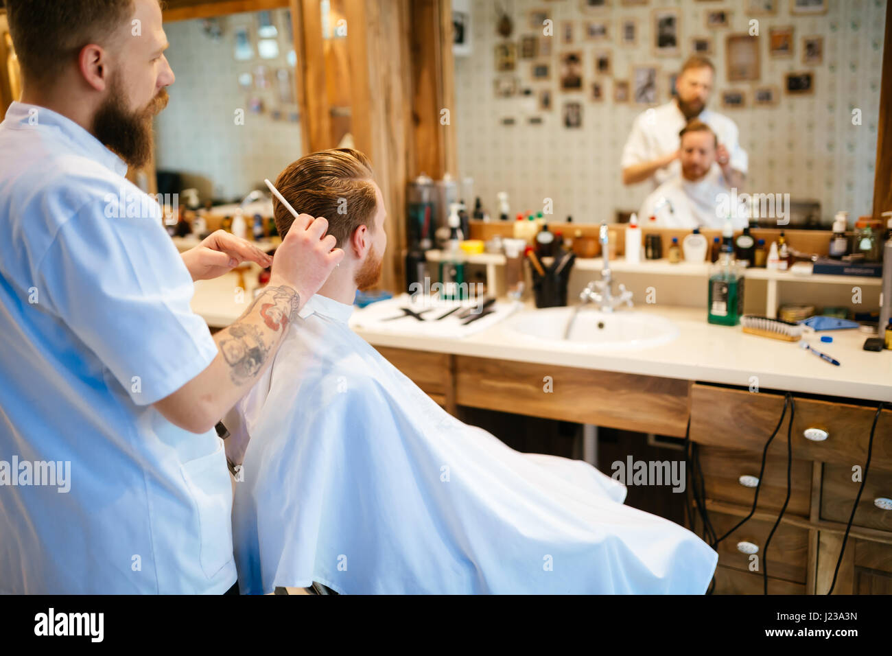 Professional barber styling hair hi-res stock photography and images ...
