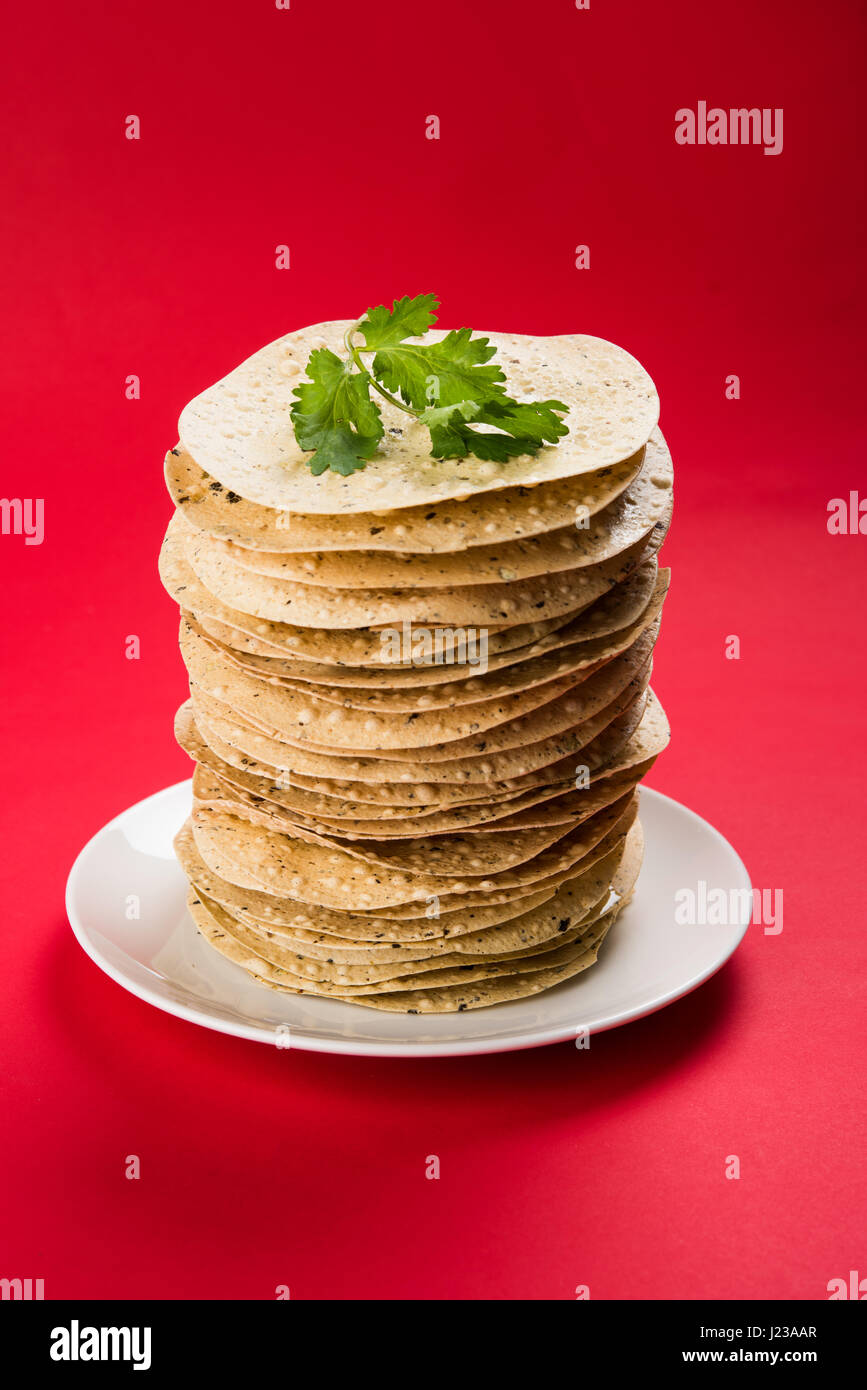 Indian snacks, deep fried crackers or papad. Mung dal and urad dal papad an Indian fried dish, which is an side dish for lunch and dinner. Stock Photo