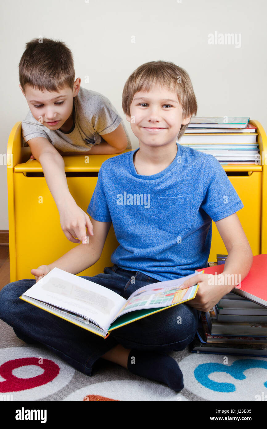 Kids reading books at home Stock Photo Alamy