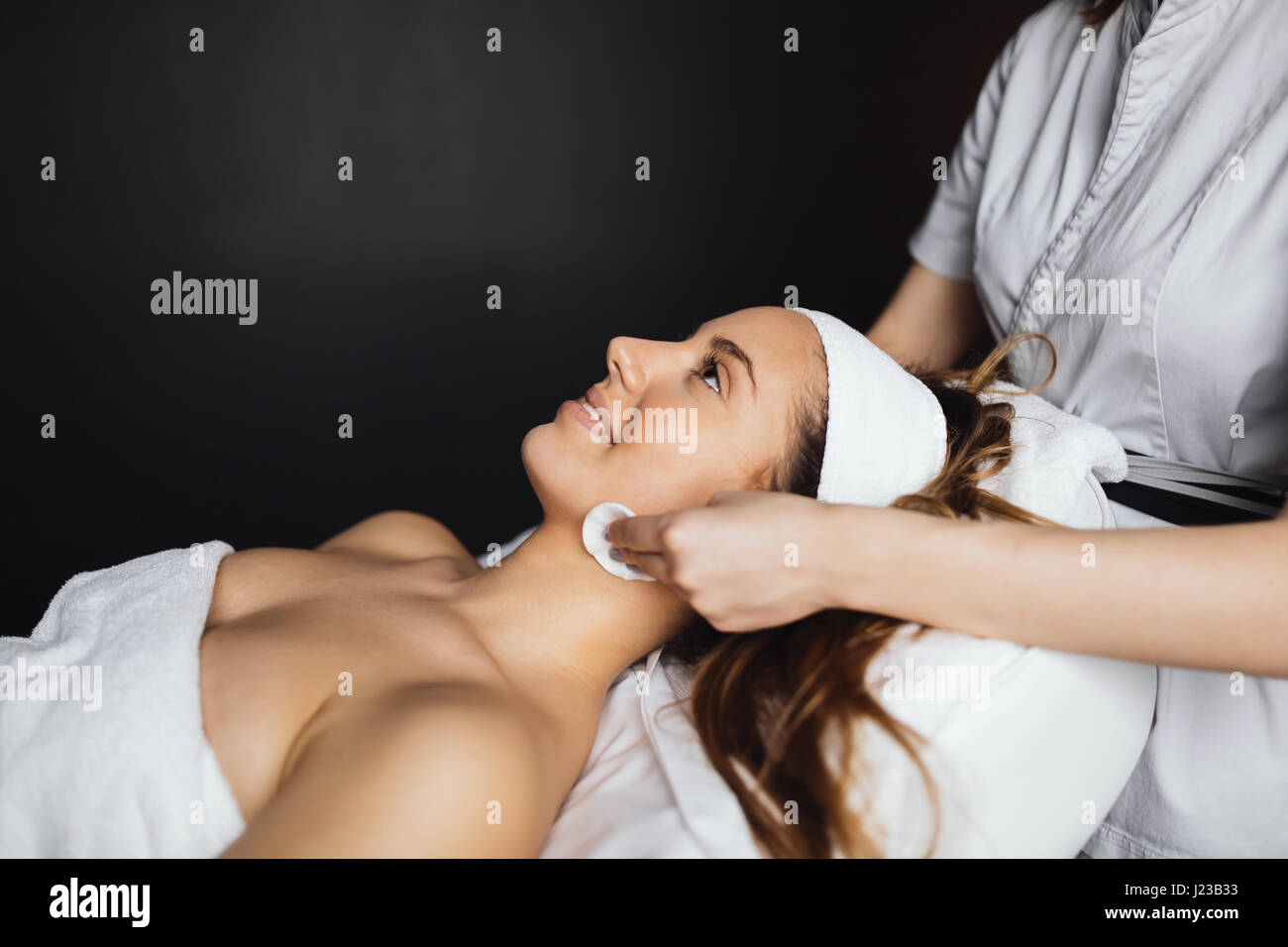 Masseur giving treatment to beautiful brunette Stock Photo