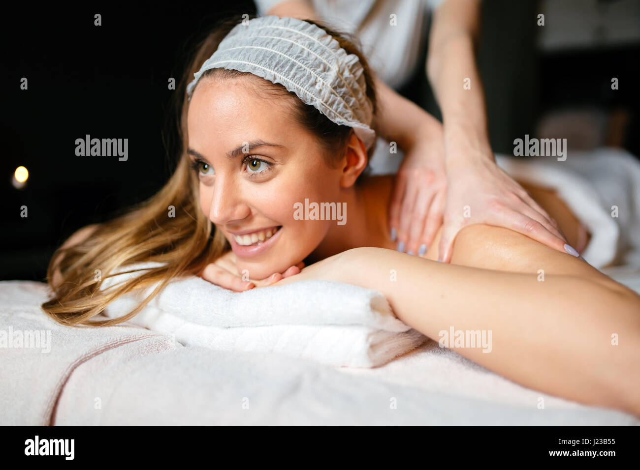 Beautiful woman enjoying massage treatment given by therapist Stock Photo