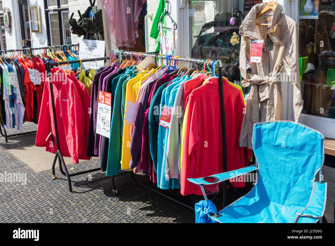 Clothing for sale on rails outside shop in West Malling, Kent, UK Stock Photo