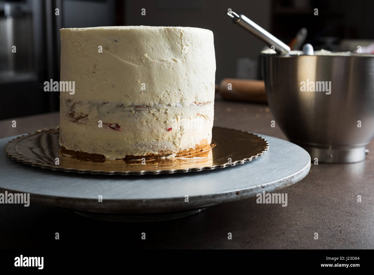 Delicious sponge cake filled with butter cream and decorated with frosting Stock Photo