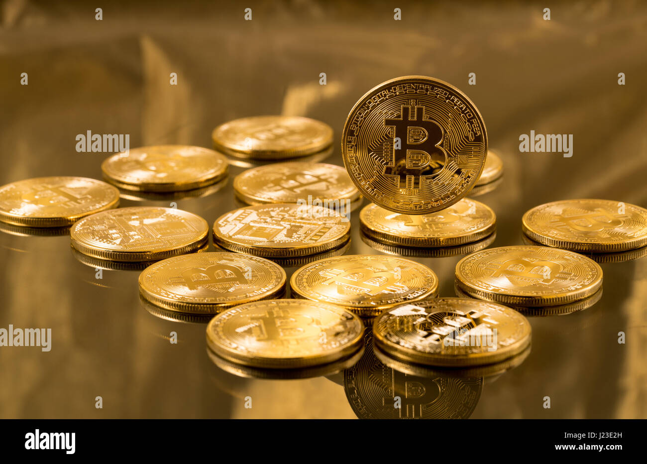 Stack of bitcoins on gold background - cyber currency and cryptocurrency vitual tokens Stock Photo