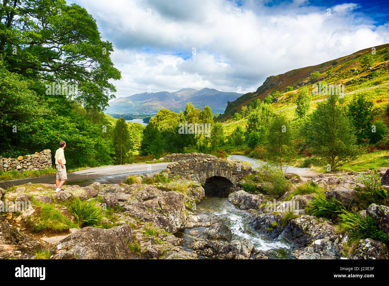 Ashness Bridge, above Derwentwater, English Lake District, England, UK with tourist walker Stock Photo