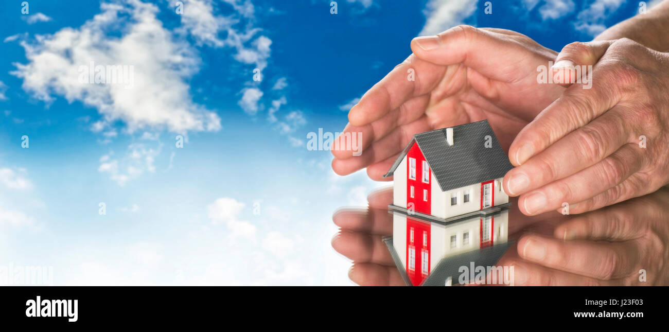 House with hands and blue sky in background Stock Photo - Alamy