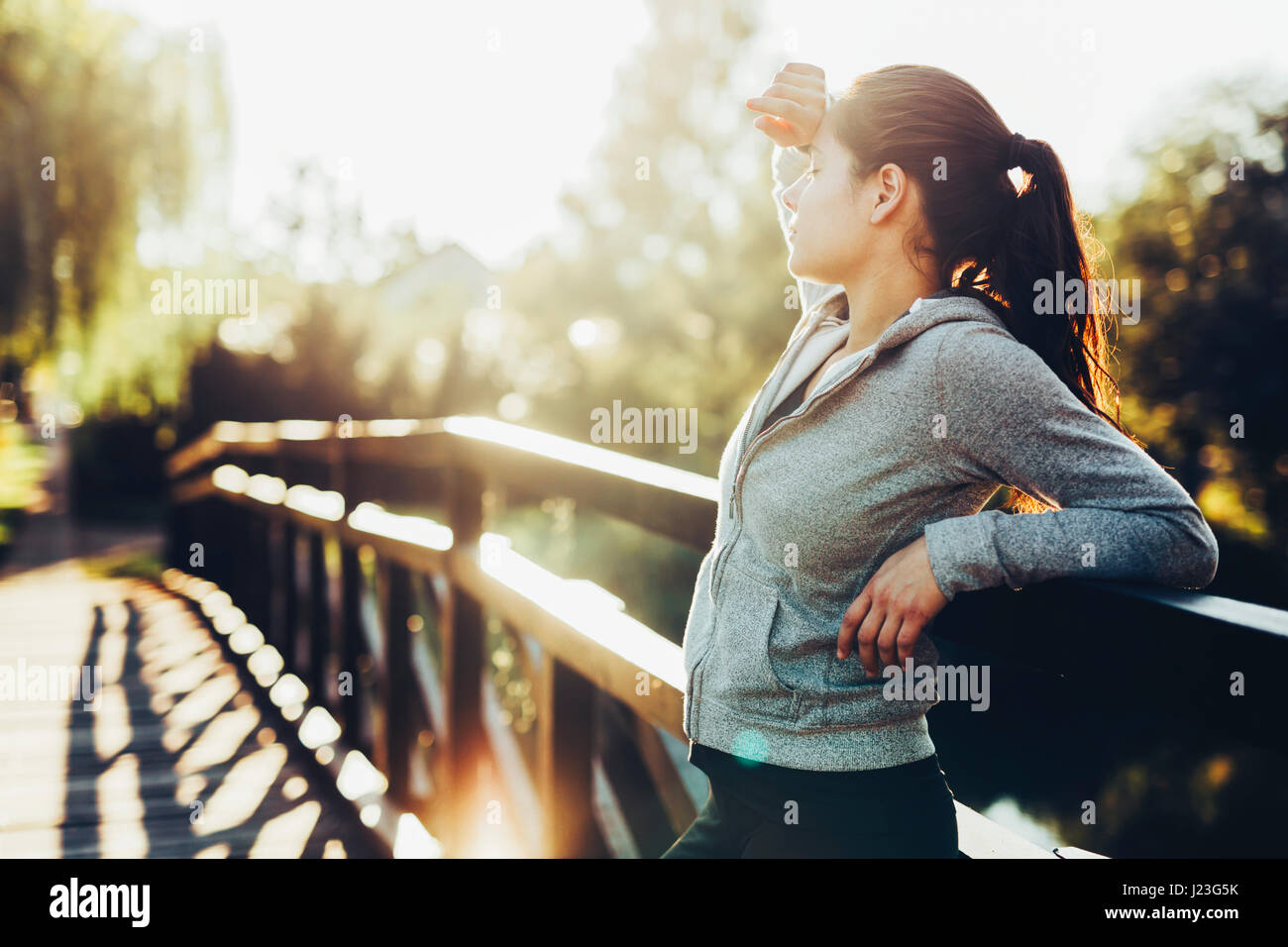Beautiful female tired after jogging taking a break Stock Photo Alamy