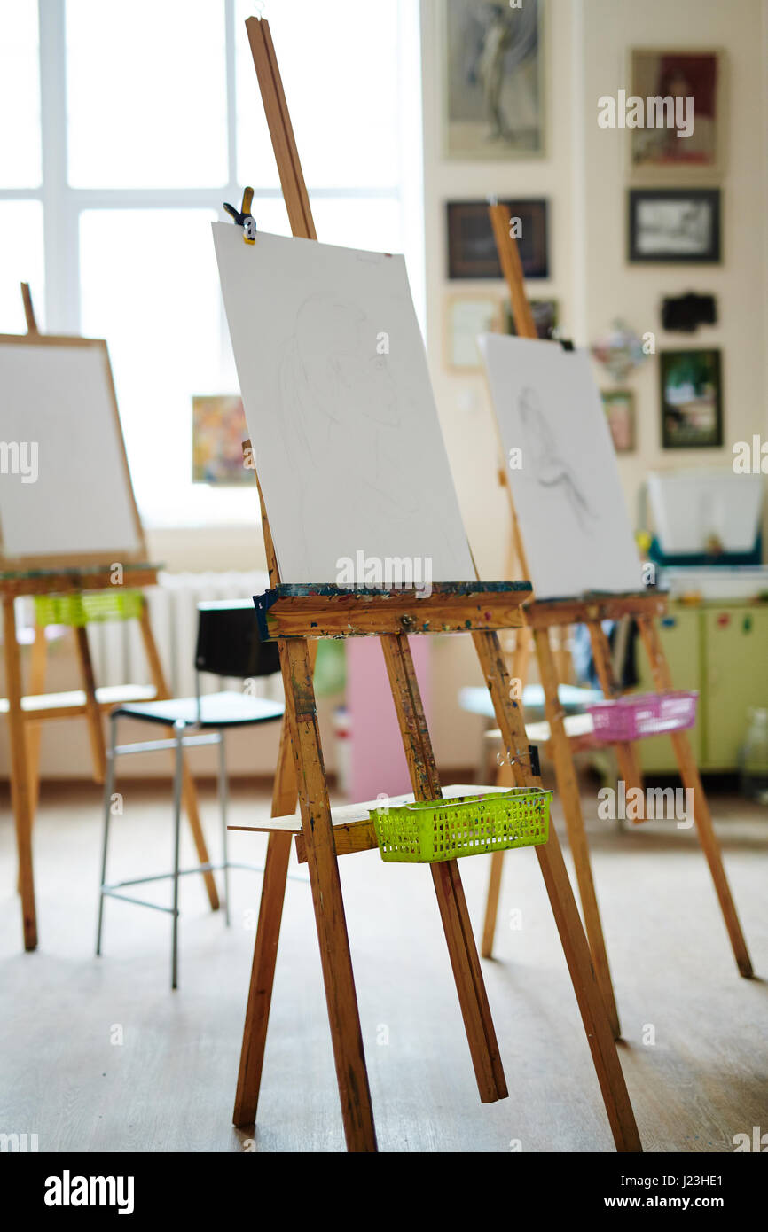 Easels with paper-sheets in empty studio of arts Stock Photo