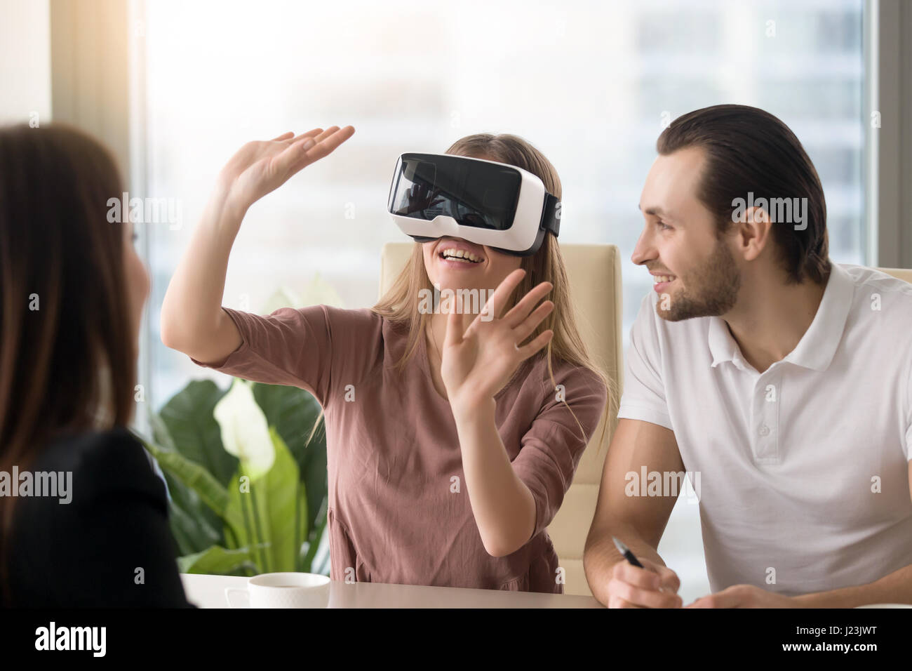 Woman wearing virtual reality headset, team developing VR glasse Stock Photo