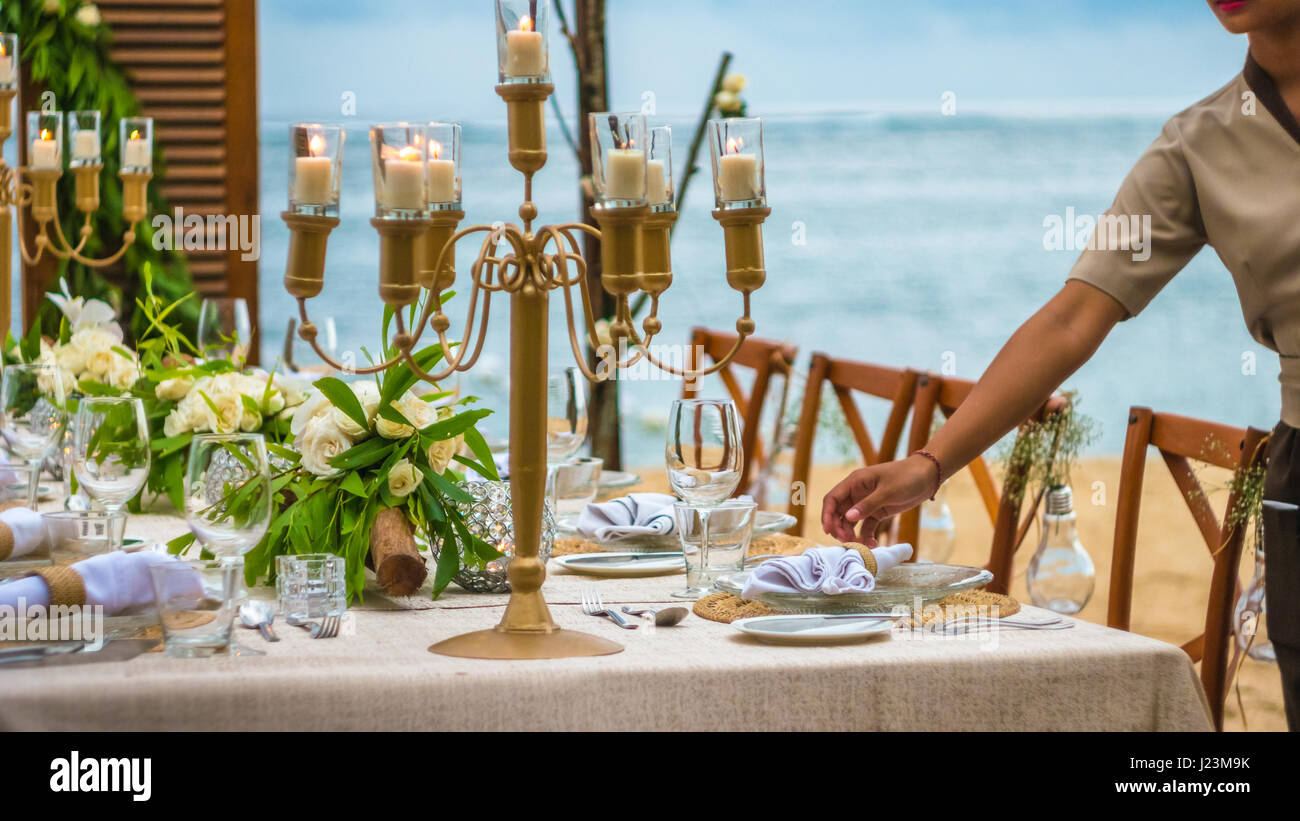 Blurred of Table in the Restaurant witch candles and servant on the Beach, Bali Stock Photo
