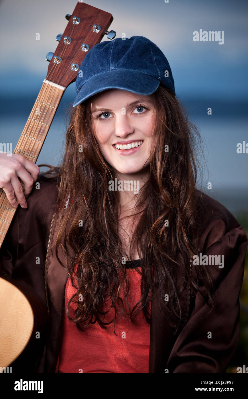 A portrait of a beautiful teenager playing guitar Stock Photo - Alamy
