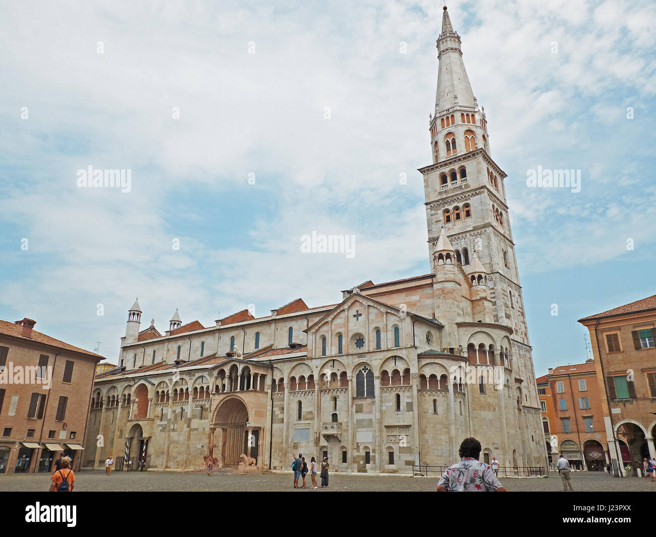 Modena, Italy - July 21, 2016.  People in front of Metropolitan Cathedral of Santa Maria Assunta e San Geminiano in Piazza Grande of Modena at sunset. Stock Photo