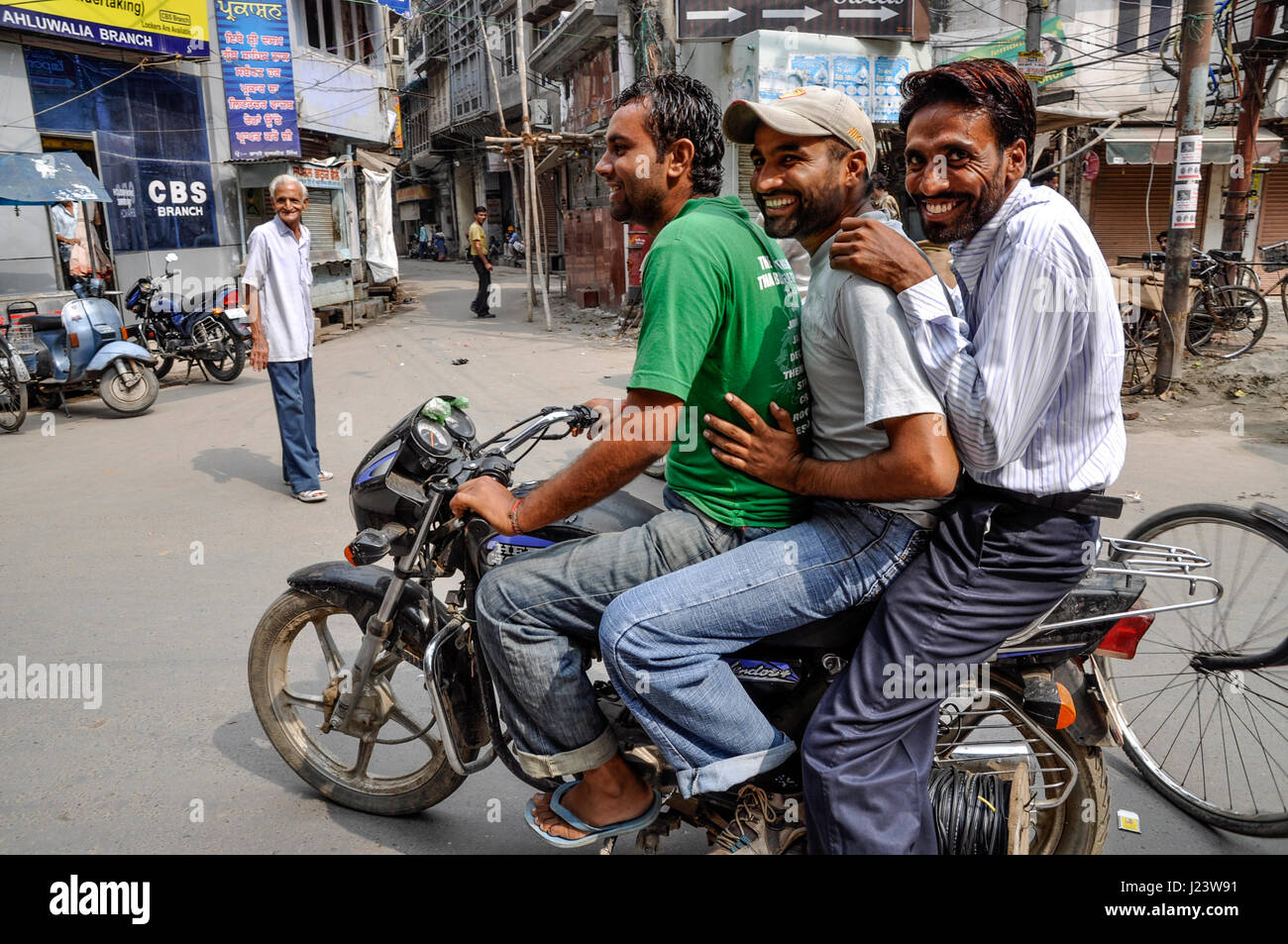 Amritsar, India, september 4, 2010: Young men on a motorcykle, smiling, India. Stock Photo
