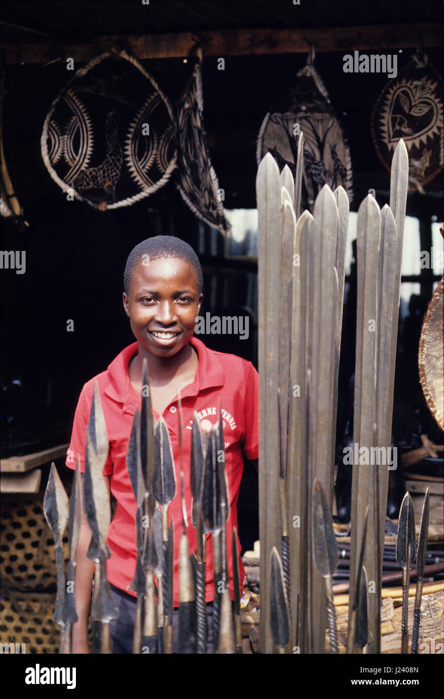 Young boy selling masai spears and shields in Mto-Wa-Mbu a small town near Lake Manyara National Park, Tanzania Stock Photo