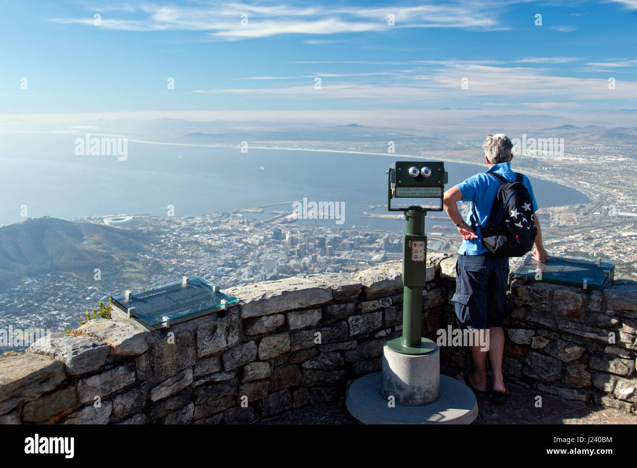 A man takes in the view of Cape Town from the top of Table Mountain, the flat-topped mountain that overlooks Cape Town, South Africa. Stock Photo