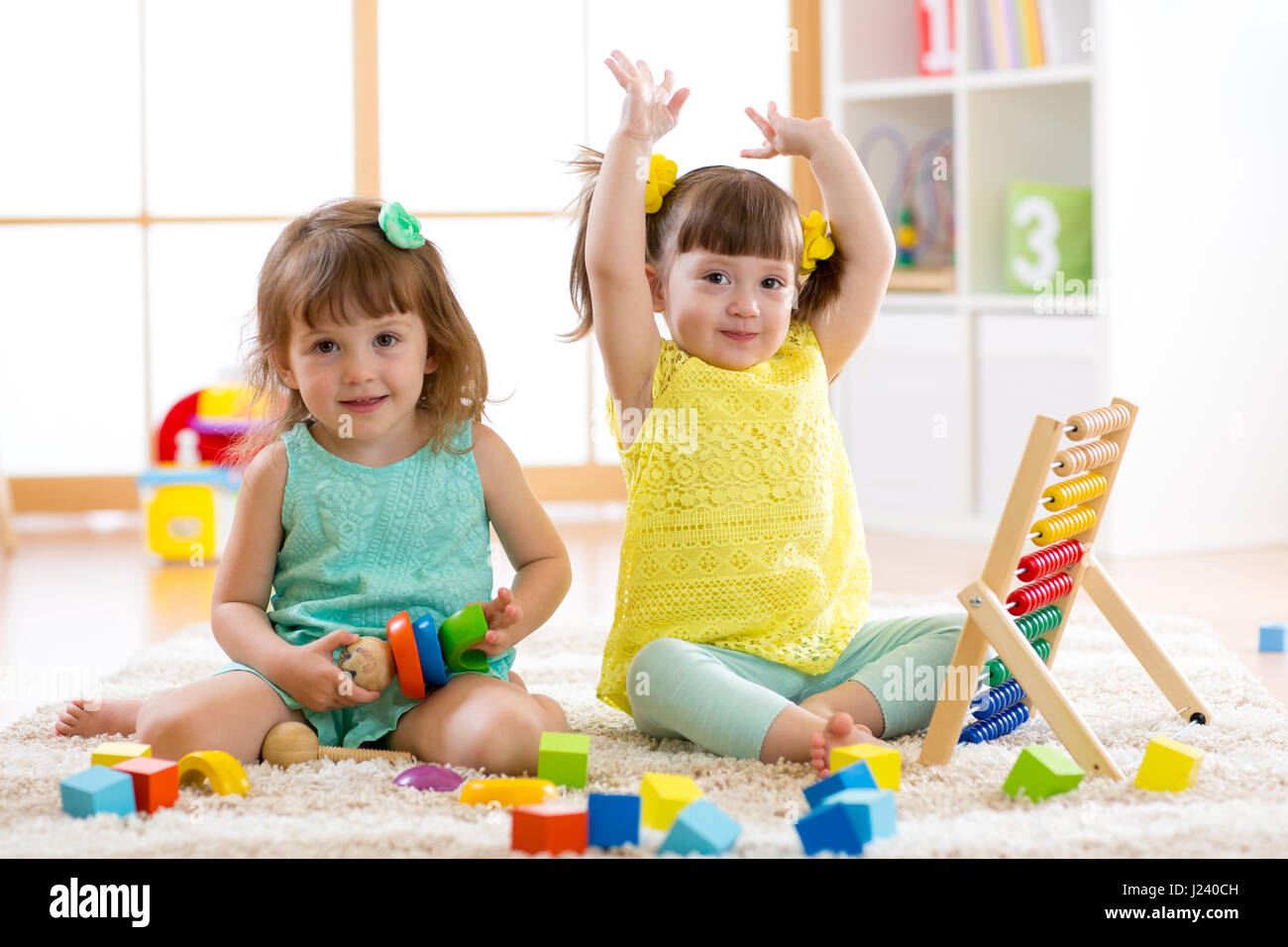 Little kids play with abacus and constructor toys, early learning Stock Photo