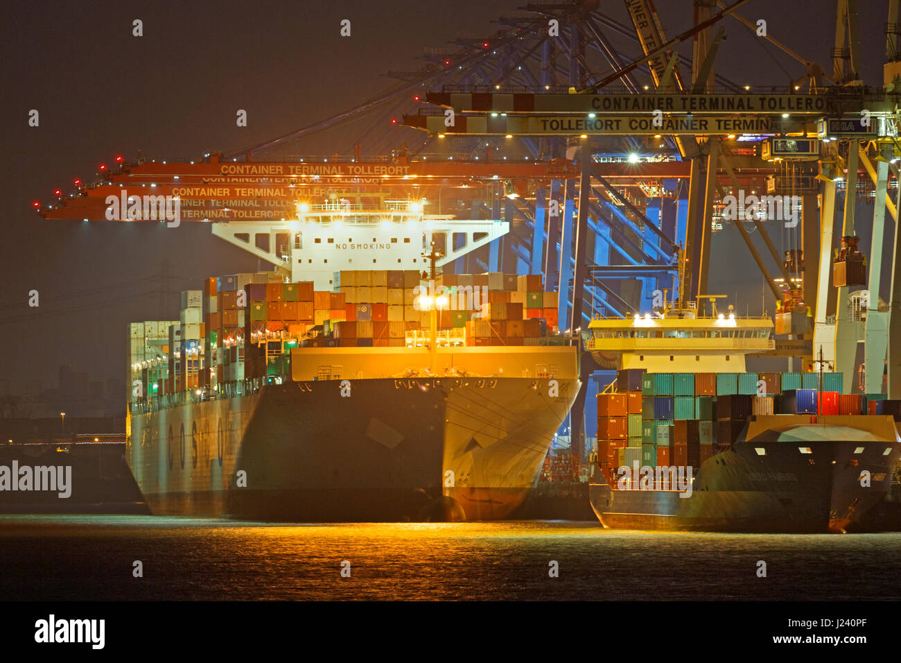 Container ship at night at Hamburg harbor, Containerterminal Tollerort, Hamburg, Germany, Europe Stock Photo