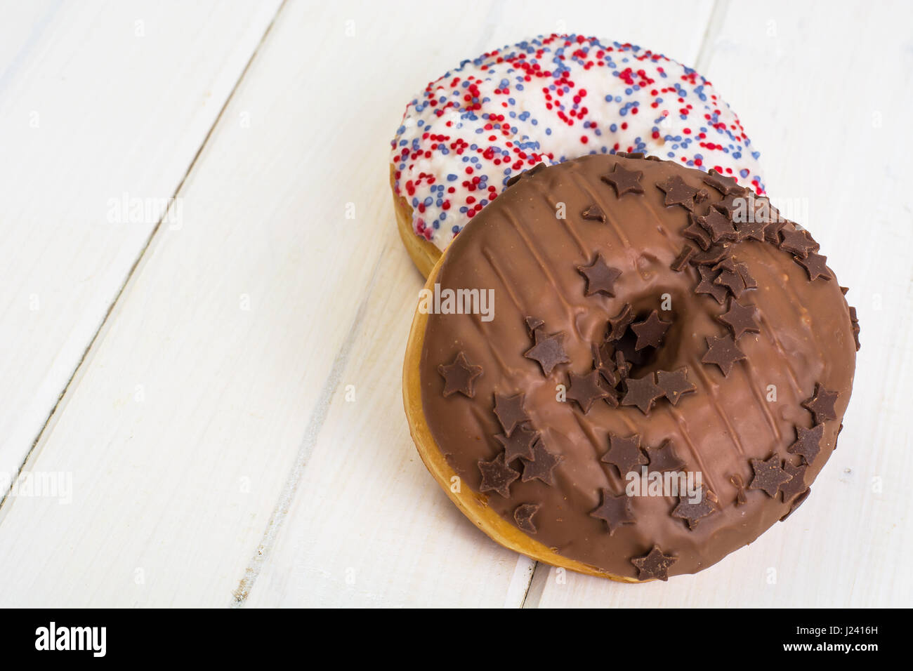 Delicious donuts on white wooden background. Studio Photo Stock Photo