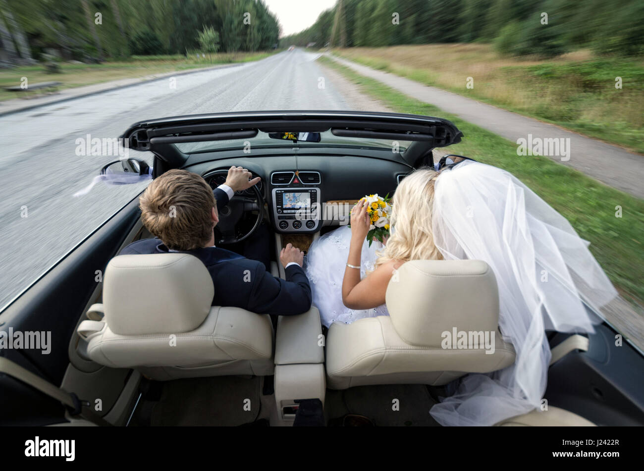 The bride and groom come with cabriolet Stock Photo - Alamy