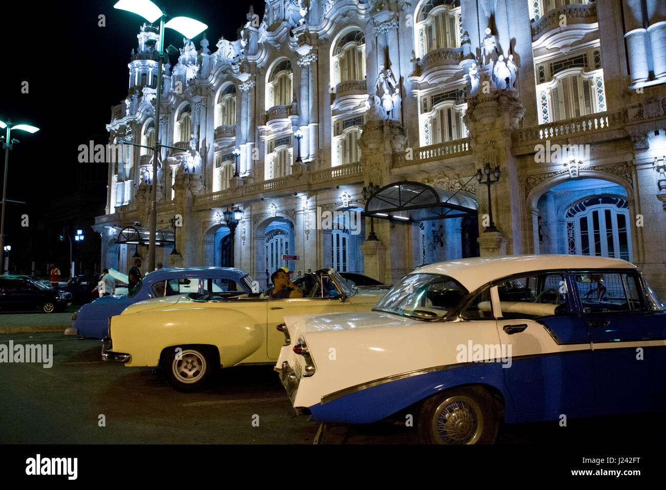 Classic American cars sit outside of the Great Theatre of Havana Alicia Alonso. Stock Photo