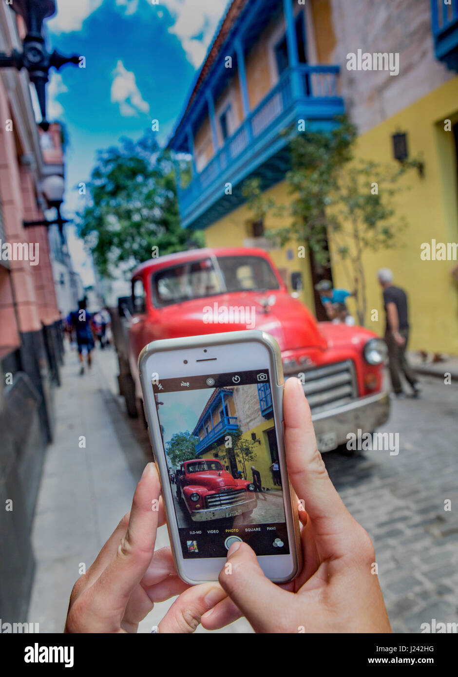 Photographer captures picture of person taking picture of vintage American truck using a phone Stock Photo
