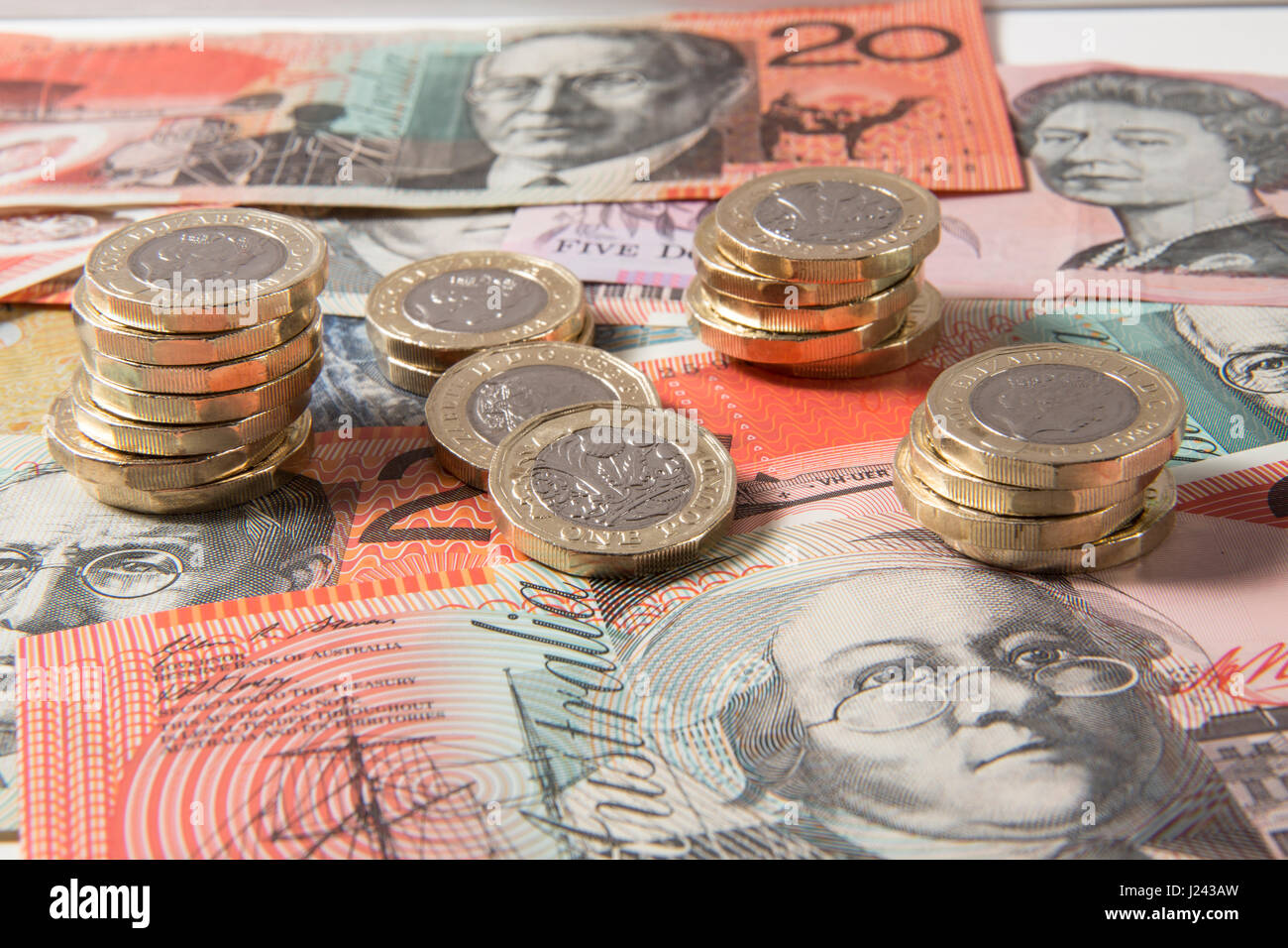 New British £1 Coins on a background of Australian Dollars Stock Photo