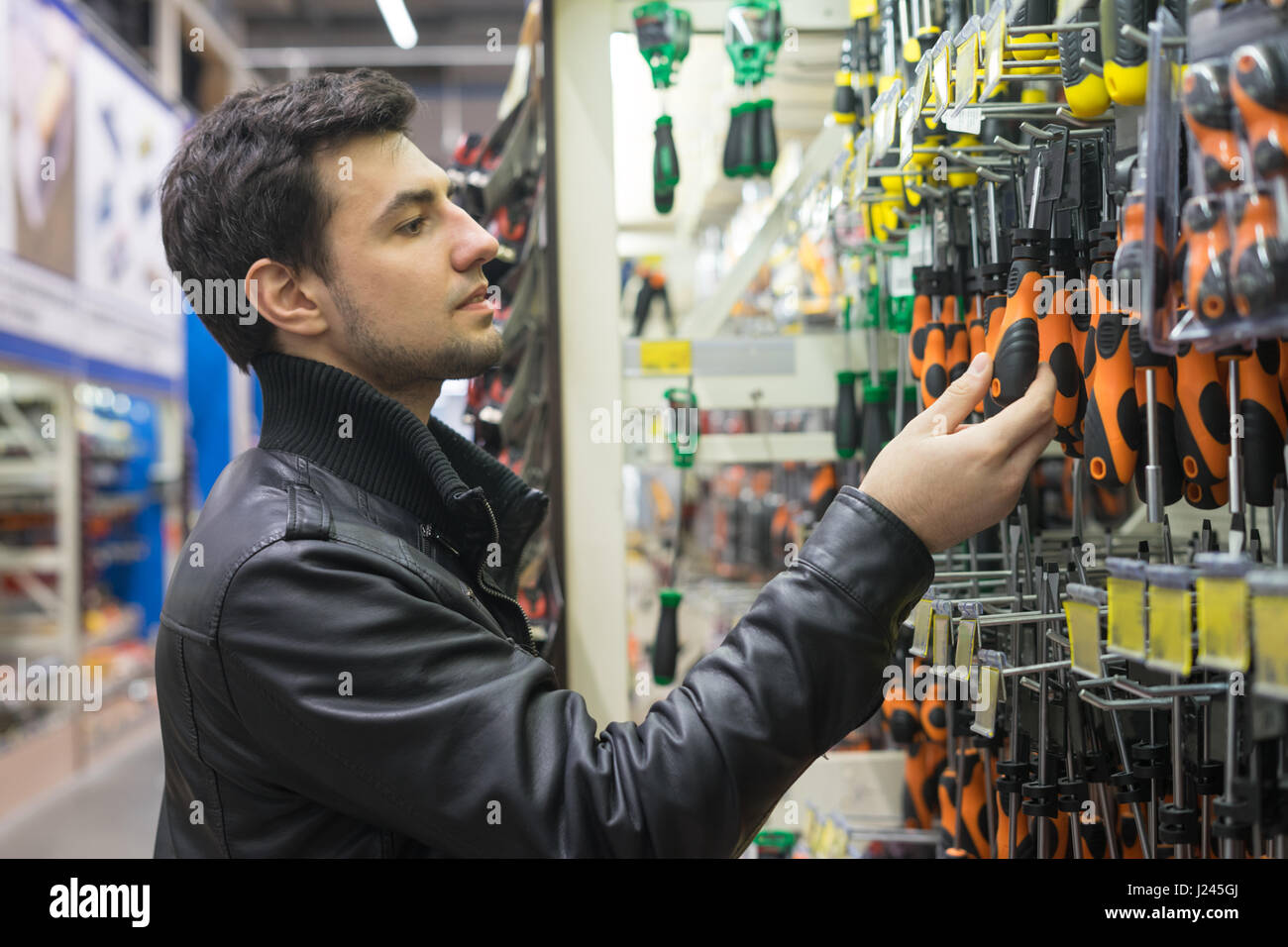 male customer choosing screwdrivers Stock Photo