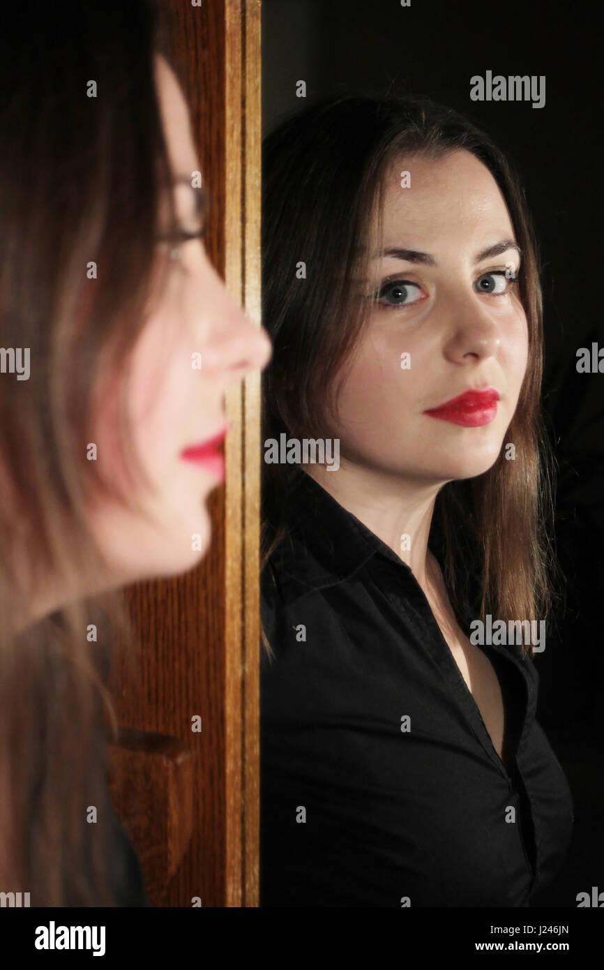 Portrait of a young brunette posing in front of mirror Stock Photo - Alamy